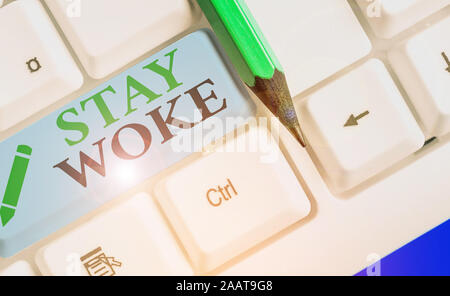 Text sign showing Stay Woke. Business photo showcasing being aware of your surroundings and things going on Keep informed Stock Photo