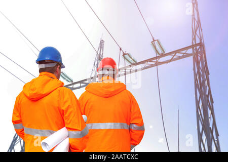 Two electrical engineers in substation, back view Stock Photo