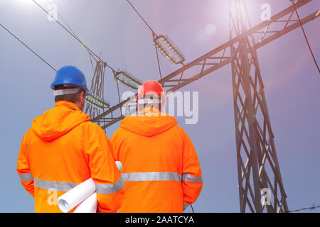 Two electrical engineers in substation, back view Stock Photo