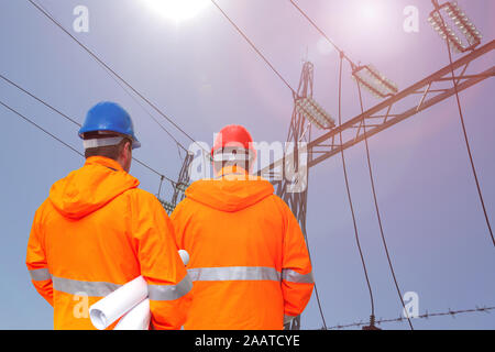 Two electrical engineers in substation, back view Stock Photo