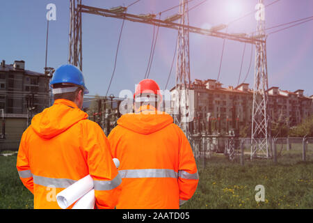 Two electrical engineers in substation, back view Stock Photo
