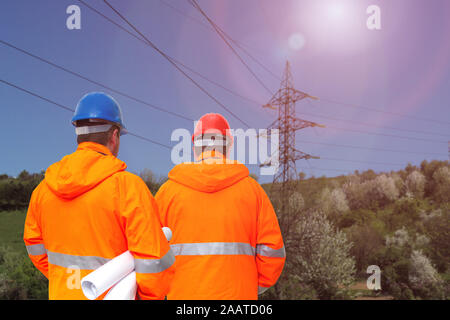 Two electrical engineers in substation, back view Stock Photo