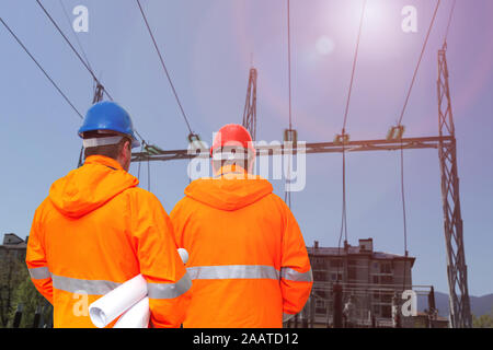 Two electrical engineers in substation, back view Stock Photo