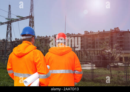 Two electrical engineers in substation, back view Stock Photo