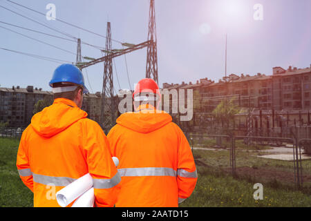 Two electrical engineers in substation, back view Stock Photo