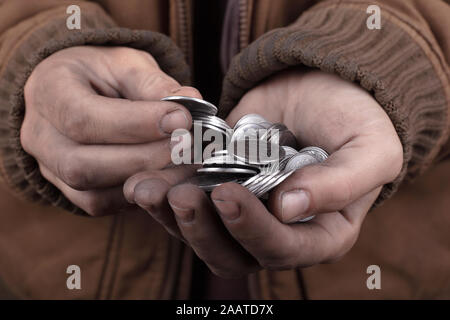 beggar concept. poor man asks for cash assistance. silver coins in the palms Stock Photo