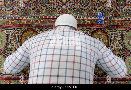 Young muslim man praying inside of beautiful mosque Stock Photo