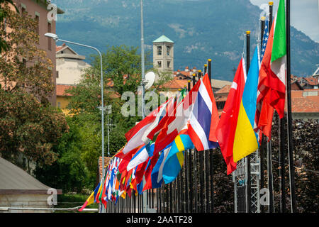 A row of international flags blowing in the breeze at a world championship event Stock Photo