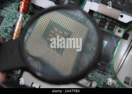 Computer repair concept Close-up view. Computer service. Man repairing notebook at the table Stock Photo