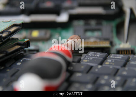 Computer repair concept Close-up view. Computer service. Man repairing notebook at the table Stock Photo