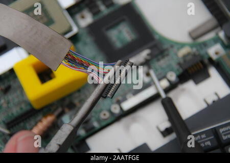 Computer repair concept Close-up view. Computer service. Man repairing notebook at the table Stock Photo