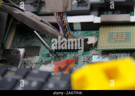 Computer repair concept Close-up view. Computer service. Man repairing notebook at the table Stock Photo