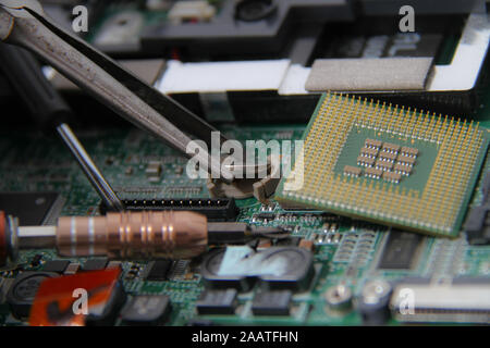 Computer repair concept Close-up view. Computer service. Man repairing notebook at the table Stock Photo