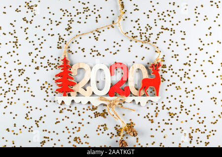 Christmas decor 2020 with little star confetti glitter on gray background. Flat lay, top view. Stock Photo