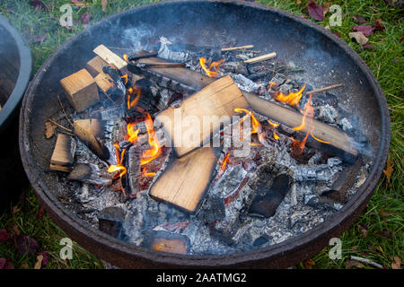 A small fire burns in a fire bowl. Stock Photo