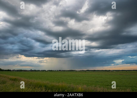 Beautiful textured clouds as a thunderstorm moves away over the countryside of Holland Stock Photo