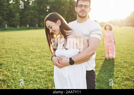 Two families of different generations embrace. Young husband and wife as well as their old parents who still love each other Stock Photo