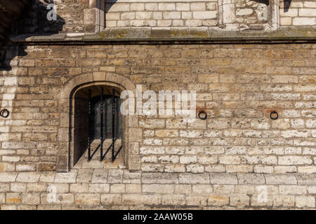 Abstract medieval brick wall with barred window Stock Photo