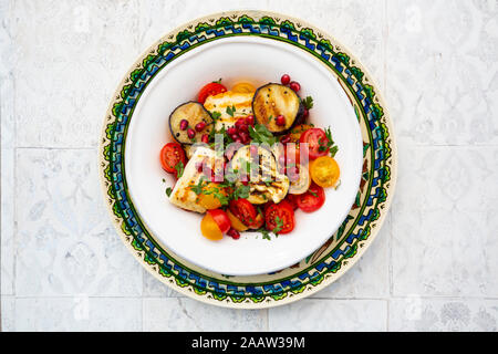 Directly below shot of salad in plate on floor Stock Photo