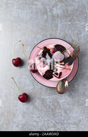 Directly above shot of cherry ice cream with chocolate sauce served in bowl on table Stock Photo