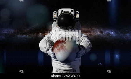 astronaut holding dwarf planet Pluto Stock Photo