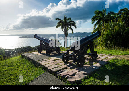 Cannons on land by sea against sky at Scarborough, Tobago, Caribbean Stock Photo