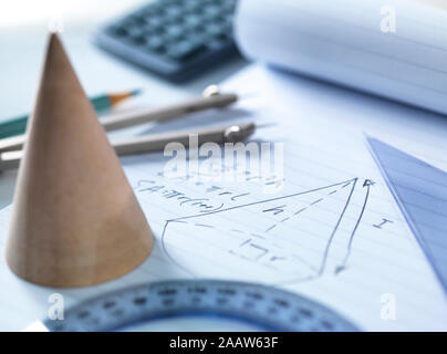 Close-up of mathematical instruments with diagram on table Stock Photo