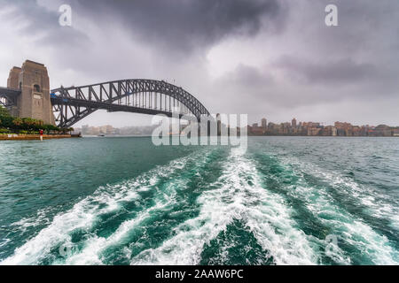 Sydney Harbor Bridge over river against cloudy sky, Sydney, Australia Stock Photo