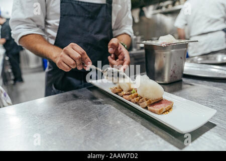 Chef garnishing plate with food Stock Photo