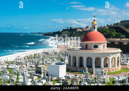 View of Santa María Magdalena de Pazzis Cemetery by sea against blue sky, Puerto Rico, Caribbean Stock Photo