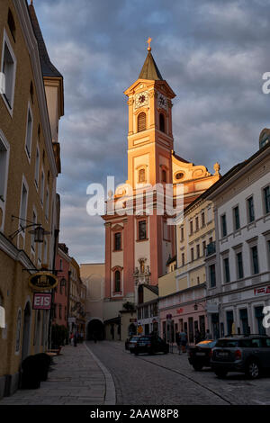 Low angle view of St. Paul Church against cloudy sky in Passau at sunset, Bavaria, Germany Stock Photo