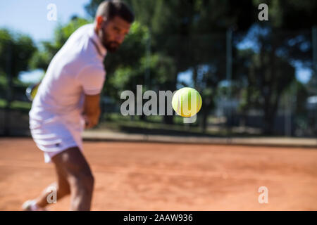 Tennis player during a tennis match, focus on tennis ball Stock Photo