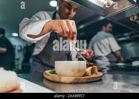 Chef garnishing chopping board with food Stock Photo