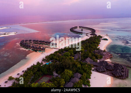 Aerial view of stilt houses at Olhuveli island during sunrise, Maldives Stock Photo