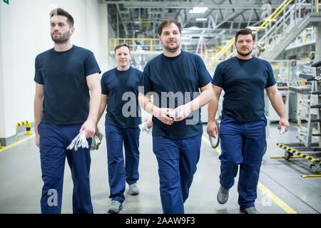 Colleagues having a break and walking in a modern factory Stock Photo