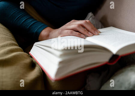 Woman reading novel, close-up Stock Photo