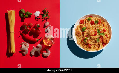 Directly above shot of shrimp pasta by ingredients on colored background Stock Photo