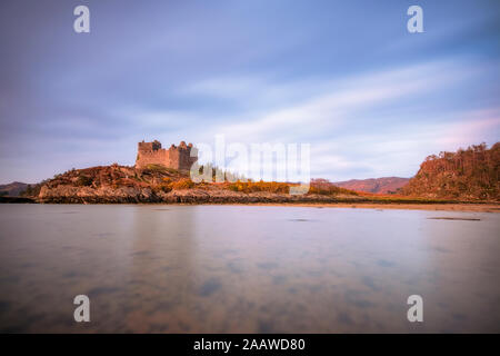 View of Loch Moidart with Castle Tioram in background against cloudy sky, Ardnamurchan, Highland, Scotland, UK Stock Photo