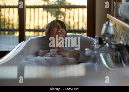 Woman having a relaxing bath in the bathtub