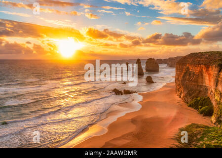 Scenic view of sea against cloudy sky at Twelve Apostles Marine National Park during sunset, Victoria, Australia Stock Photo