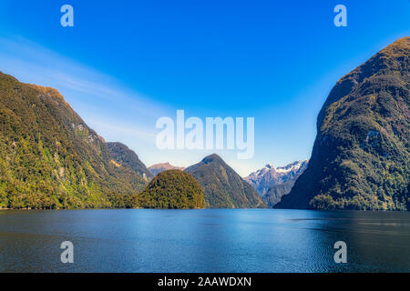 Scenic view of Doubtful Sound against blue sky in Fiordland National Park at Te Anau, South Island, New Zealand Stock Photo