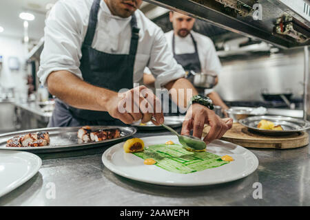 Chef garnishing plate with food Stock Photo