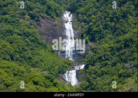 Scenic view of waterfall on mountain amidst trees, Grande Terre, New Caledonia Stock Photo