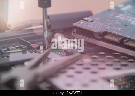 Computer service. Man repairing notebook at the table Stock Photo