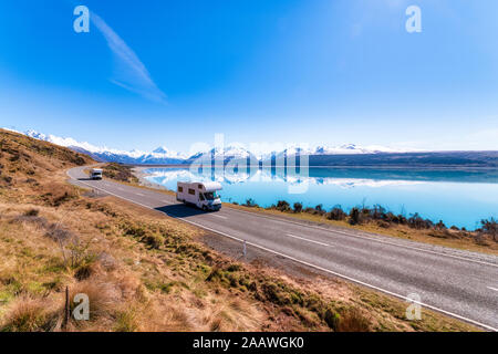 New Zealand, South Island, Motor home driving along highway surrounding Lake Pukaki Stock Photo
