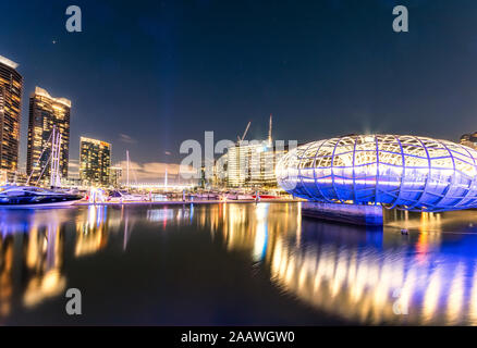 Illuminated Webb Bridge over Yarra river in Docklands against sky at night, Melbourne, Australia Stock Photo