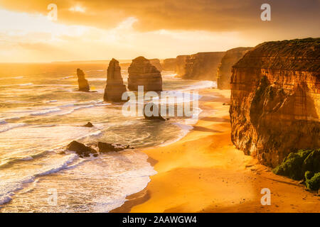 Scenic view of sea against cloudy sky at Twelve Apostles Marine National Park during sunset, Victoria, Australia Stock Photo