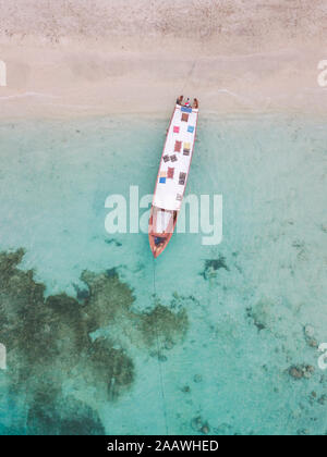 Drone shot of boat moored at beach in Gili-Air Island, Bali, Indonesia Stock Photo