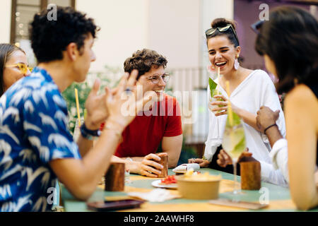 Friends having fun at a party, drinking together Stock Photo