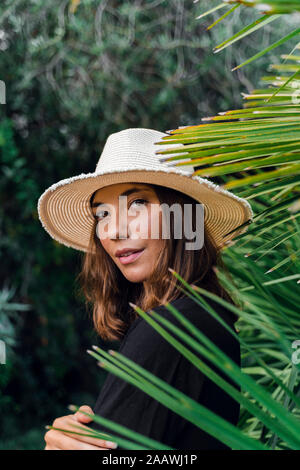 Portrait of young woman wearing summer hat Stock Photo